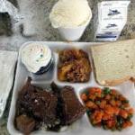 Photo of a Senior Resources full meal featuring beef, rice, carrots, green peas, bread, cupcakes and ice cream.