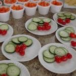 Photo of plates of cucumber, tomato and a cup of carrots. Nutrition area food at the Senior Resource Center.
